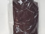 a piece of chocolate in a plastic bag on a white surface