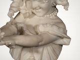 statue of a young girl holding a bird on a pedestal