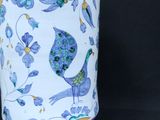 a blue and white vase with a bird design on it