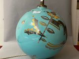 a blue ball with gold designs on it on a table