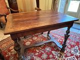 a large wooden table in the middle of a living room