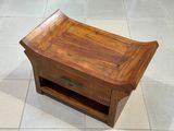 a small wooden table with a drawer on it