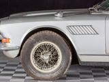 a silver car that is sitting on a checkered floor