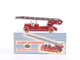 a red toy fire truck with a ladder on top of it