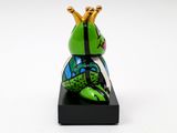 green frog with a crown on its head sitting on top of a black stand