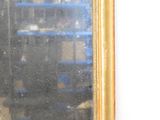 a mirror hanging on a wall in a room