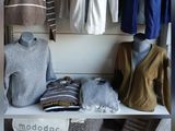 a closet full of clothes and clothing items on display