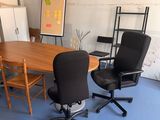 a room with a table and chairs in it