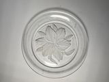 a glass plate with a flower in the middle of it