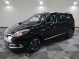 the black minivan is parked in a room with a checkered floor