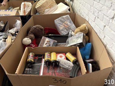 a box full of stuff sitting on the floor next to a brick wall