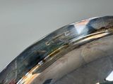 a close up of a silver plate on a table