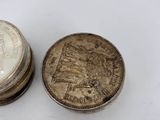 two coins sitting next to each other on a white surface