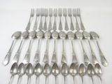 a lot of silver spoons and forks on the table