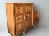 a wooden cabinet with drawers and drawers on it