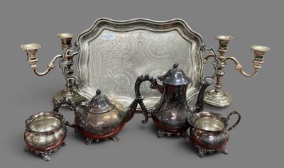 a silver tray with a silver tea set on top of it