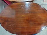 a wooden table with a glass top in a room