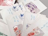 many envelopes with stamps on them sitting on a table