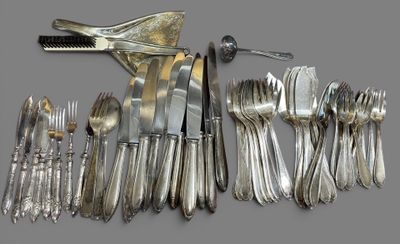 a lot of silverware on a table with a knife and fork
