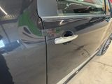 a close up of a car door handle with a sticker on it