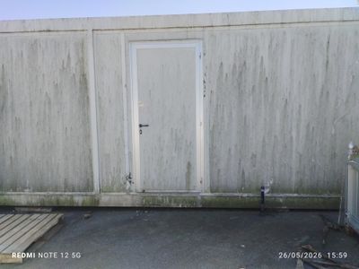 une porte blanche située sur le côté d'un immeuble