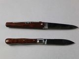 two knives that are sitting next to each other on a table