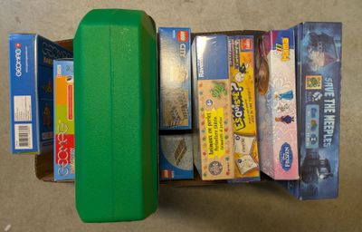 a green suitcase with a lot of different items inside of it