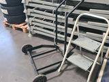 a cart that is sitting next to a pile of tires