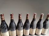 six bottles of wine are lined up in a row on a table