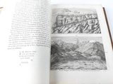 an open book with a picture of mountains in it