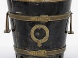 a black bucket with a brass handle on a white background