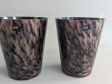 two cups that are sitting next to each other on a table