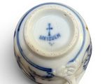 a small cup with a blue and white design on it