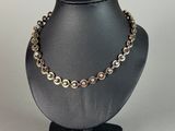 a close up of a mannequin with a necklace on it
