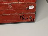 painting of a red wooden box with black writing on it