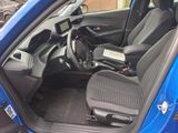 the interior of a blue car with black seats and a steering wheel
