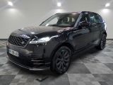 a black land rover parked on a checkered floor in a showroom