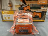 a box of stihl batteries sitting on top of a table