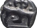 an image of a black coin with a face on it