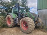 a tractor that is parked on the side of the road