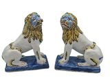 pair of blue and white ceramic lions with gold manes