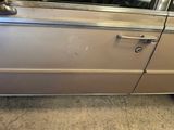 a picture of a car door handle and door handle on a silver car