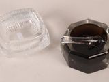 a glass ashtray and a glass ashtray on a table