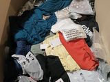 a cardboard box filled with clothes and other items
