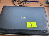 a laptop computer sitting on a desk with a yellow sticker on it