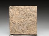 marble block on stand on grey background with black background