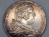 une pièce en argent portant le portrait d'un homme