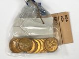 a bag of gold coins and a piece of paper on a table