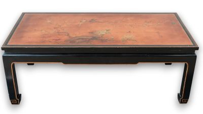 une table basse de style oriental avec un plateau en cuivre et des pieds noirs
