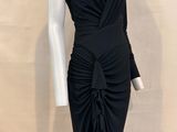 the mannequin is wearing a black dress with a bow on it